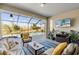 Screened-in lanai with comfortable seating, a TV, and a view of the pool and backyard at 15607 White Linen Dr, Lakewood Ranch, FL 34211