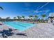 Community pool with lounge chairs, palm trees, and clear blue skies create an inviting outdoor oasis at 15607 White Linen Dr, Lakewood Ranch, FL 34211