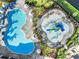 Overhead view of a community pool area featuring a resort-style pool and a splash park at 15607 White Linen Dr, Lakewood Ranch, FL 34211