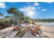 Cozy lakeside firepit area with Adirondack chairs for relaxing by the water at 17522 Northwood Pl, Bradenton, FL 34202