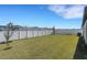 Spacious backyard featuring a well-maintained lawn and a white privacy fence at 1901 Everson St, Bradenton, FL 34208