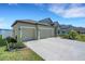 Exterior showcasing the long driveway, two-car garage, and well-manicured front yard at 1901 Everson St, Bradenton, FL 34208