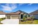 Charming single-story home with a well-maintained lawn and attached three car garage at 1901 Everson St, Bradenton, FL 34208