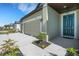 Beige single-Gathering house with well-maintained lawn, two car garage, and teal-colored front door at 1901 Everson St, Bradenton, FL 34208