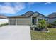 Inviting single-Gathering home with a three-car garage and meticulously landscaped front yard at 1901 Everson St, Bradenton, FL 34208