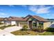Attractive home featuring a three-car garage, verdant lawn, and well-kept landscaping at 1901 Everson St, Bradenton, FL 34208