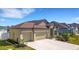 Beautiful home with a manicured front lawn and a spacious driveway leading to a three car garage at 1901 Everson St, Bradenton, FL 34208
