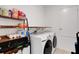 Functional laundry room with shelving and modern appliances, providing efficient space for laundry tasks at 1901 Everson St, Bradenton, FL 34208