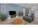 Comfortable living room with blue accent wall, modern fireplace, and views of kitchen at 1901 Everson St, Bradenton, FL 34208