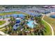 Aerial view of a community pool surrounded by townhomes and a tranquil pond at 1901 Everson St, Bradenton, FL 34208