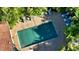 Aerial view of the backyard showcasing a refreshing pool, outdoor dining, and lush tropical landscaping at 2047 Roselawn St, Sarasota, FL 34231