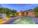 Backyard at dusk with inviting pool, outdoor dining area, and lush landscaping, ideal for evening relaxation at 2047 Roselawn St, Sarasota, FL 34231