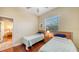 Bright bedroom featuring two twin beds with hardwood floors and window with blinds at 2047 Roselawn St, Sarasota, FL 34231