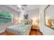 Bedroom featuring a double bed, hardwood floors, and a large window at 2047 Roselawn St, Sarasota, FL 34231