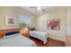 Bright bedroom featuring twin beds, ceiling fan and hardwood floors at 2047 Roselawn St, Sarasota, FL 34231