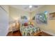 This bedroom features natural light, wood floors, and a tropical aesthetic at 2047 Roselawn St, Sarasota, FL 34231