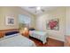 Bright bedroom featuring two twin beds with hardwood floors and window with blinds at 2047 Roselawn St, Sarasota, FL 34231