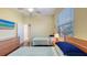 Bedroom with hardwood floors, two twin beds and a window with blinds at 2047 Roselawn St, Sarasota, FL 34231