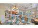Open-concept dining room area showcases the table setting, chandelier, and view into the living room at 2047 Roselawn St, Sarasota, FL 34231