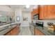 The open kitchen has granite countertops, stainless appliances, and wood cabinets at 2047 Roselawn St, Sarasota, FL 34231