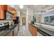 Galley kitchen features stainless steel appliances, granite countertops and wood cabinets at 2047 Roselawn St, Sarasota, FL 34231