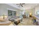 Open-concept living room features recessed lighting, ceiling fan, and views into the dining area at 2047 Roselawn St, Sarasota, FL 34231