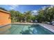 Beautiful in-ground pool surrounded by lush tropical landscaping at 2047 Roselawn St, Sarasota, FL 34231