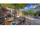 Inviting covered patio features a dining table and access to a refreshing pool surrounded by lush landscaping at 2047 Roselawn St, Sarasota, FL 34231