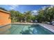 Sparkling pool is surrounded by beautiful, mature landscaping and brick patio, creating a private oasis at 2047 Roselawn St, Sarasota, FL 34231