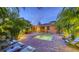 Tropical outdoor living at its finest with a pool and inviting patio with sun loungers and exterior dining at 2047 Roselawn St, Sarasota, FL 34231