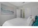 Bedroom features a white bed, closets, and a calming ocean view at 2208 Midnight Pearl Dr, Sarasota, FL 34240