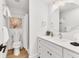 Bright bathroom with white cabinets, sink, and shower at 310 Magnolia Ave, Anna Maria, FL 34216