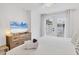 Bright bedroom with white walls, wood-look floors, and french doors at 310 Magnolia Ave, Anna Maria, FL 34216
