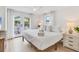 Bright bedroom with white walls, ceiling fan, and french doors at 310 Magnolia Ave, Anna Maria, FL 34216