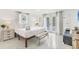 Bright and airy bedroom with access to a patio and ensuite bath at 310 Magnolia Ave, Anna Maria, FL 34216