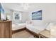 Bedroom with two twin beds, a ceiling fan, and beach-themed art at 310 Magnolia Ave, Anna Maria, FL 34216