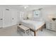 Bright bedroom with white walls, ceiling fan, and ensuite bathroom at 310 Magnolia Ave, Anna Maria, FL 34216