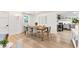 Stylish dining area with a wooden table, modern chairs, and contemporary lighting at 310 Magnolia Ave, Anna Maria, FL 34216