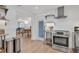 Well-designed kitchen featuring stainless steel appliances, open shelving, and modern fixtures at 310 Magnolia Ave, Anna Maria, FL 34216