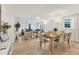 Open-concept living and dining area with modern furniture and bright, natural light at 310 Magnolia Ave, Anna Maria, FL 34216