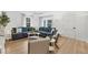 Bright living room with hardwood floors, a large sectional sofa, and modern decor at 310 Magnolia Ave, Anna Maria, FL 34216