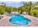 Inviting private pool with brick surround and lush landscaping at 310 Magnolia Ave, Anna Maria, FL 34216