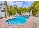 Private pool surrounded by lush landscaping at 310 Magnolia Ave, Anna Maria, FL 34216