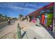 Street view of shops and people riding bikes on a sunny day at 310 Magnolia Ave, Anna Maria, FL 34216