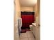 Cozy bathroom features a vanity and a shower with a red curtain and a tile floor at 3305 13Th W Ave, Bradenton, FL 34205