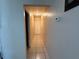 Hallway with neutral walls and tiled flooring with doors leading into other rooms at 3305 13Th W Ave, Bradenton, FL 34205