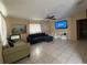 Spacious living room features neutral walls, tile flooring and a ceiling fan, creating a welcoming atmosphere at 3305 13Th W Ave, Bradenton, FL 34205