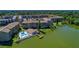 Aerial view of the lakeside community, highlighting the pool, private dock and manicured landscaping at 3528 Lake Bayshore Dr # K-115, Bradenton, FL 34205