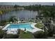 Elevated view of a pool and lake, showcasing a community's recreational amenities and waterfront setting at 3528 Lake Bayshore Dr # K-115, Bradenton, FL 34205