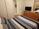 Well-lit bedroom with television, dresser, closet, and tidy finishes at 3528 Lake Bayshore Dr # K-115, Bradenton, FL 34205